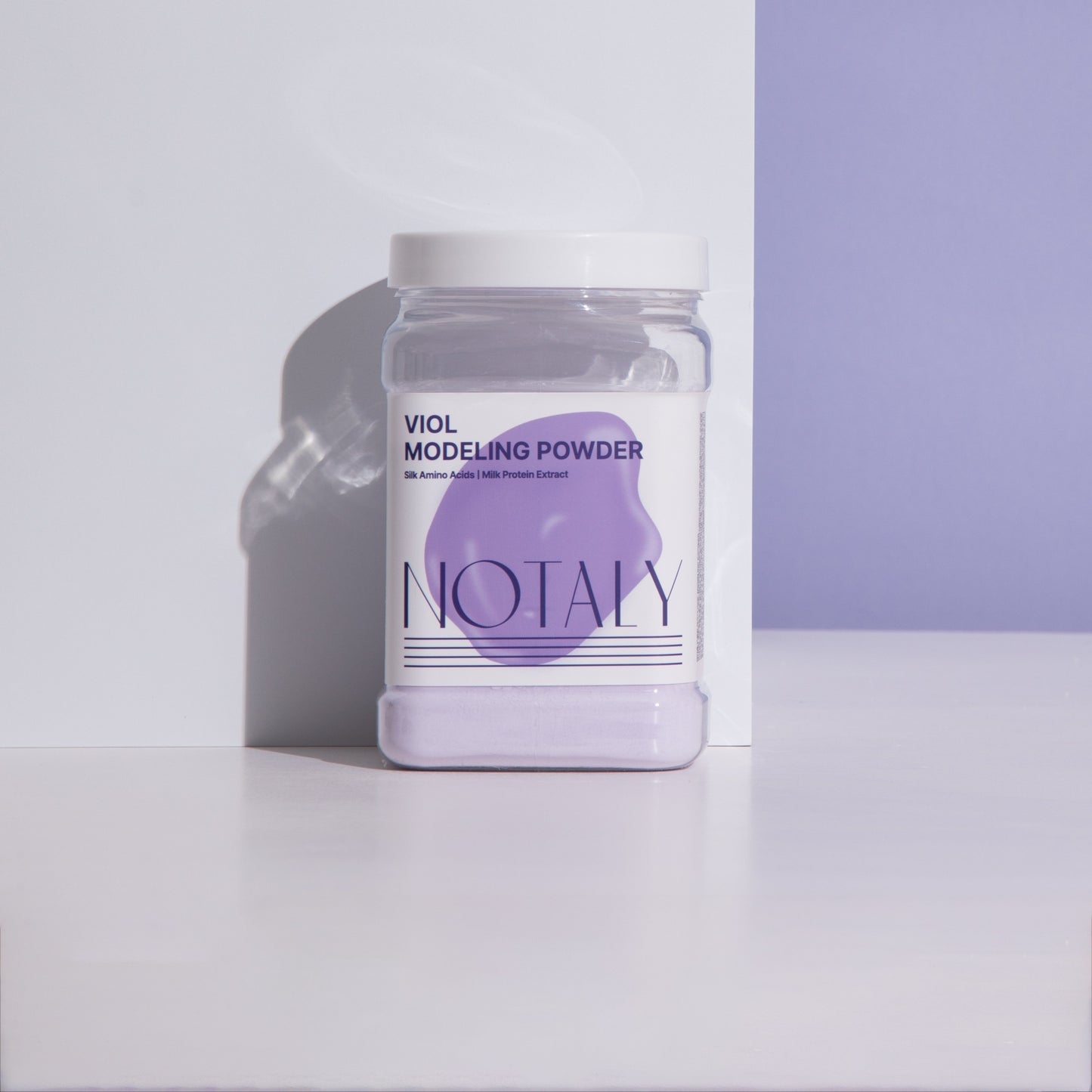 NOTALY VIOL Modeling Powder in a clear container against a lavender background, featuring premium Korean modeling mask ingredients.