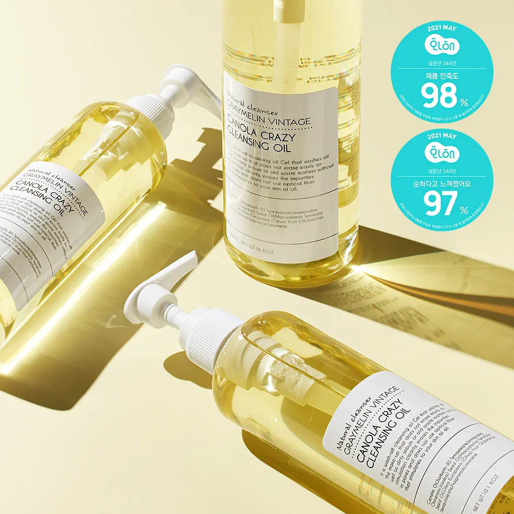 GRAYMELIN Canola Crazy Cleansing Oil 500ml bottles on a reflective surface, Korean cleansing oil for makeup removal.