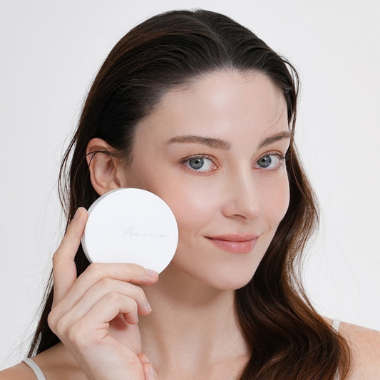 Woman holding Amica Ai Recovery Balm Cushion SPF35 PA++ with a radiant complexion, showcasing the SPF35 skin recovery cushion.